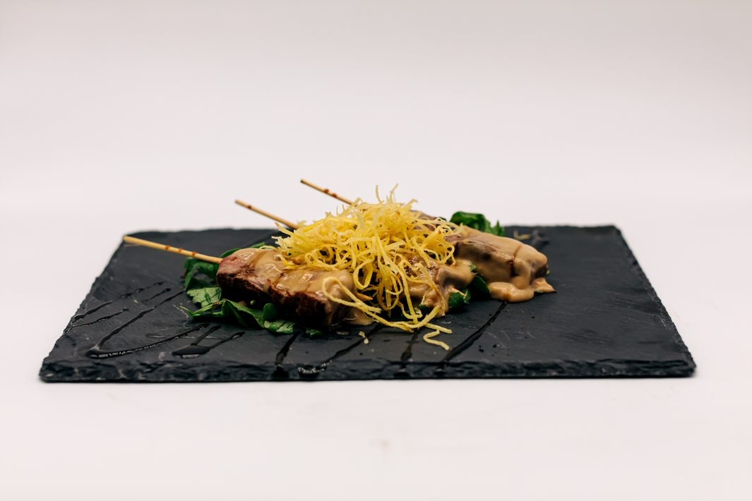 Filet Mignon Skewers - Filet Mignon set a top arugula with a lemongrass sauce media 1