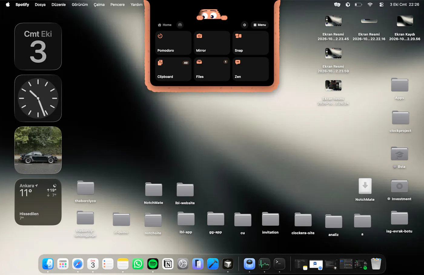 The NotchMate panel opened from the notch, showing a grid of quick tools